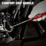 A gloved hand uses a Milwaukee Mechanic Hand Tool with a comfort grip handle to work on a car engine. The tool is a long, thin screwdriver or pick inserted into an automotive component.
