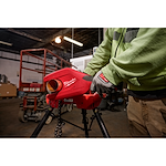 Image of the Milwaukee M12 Brushless 1-1/4" - 2" Copper Tubing Cutter being used by a worker on a jobsite to cut copper pipe