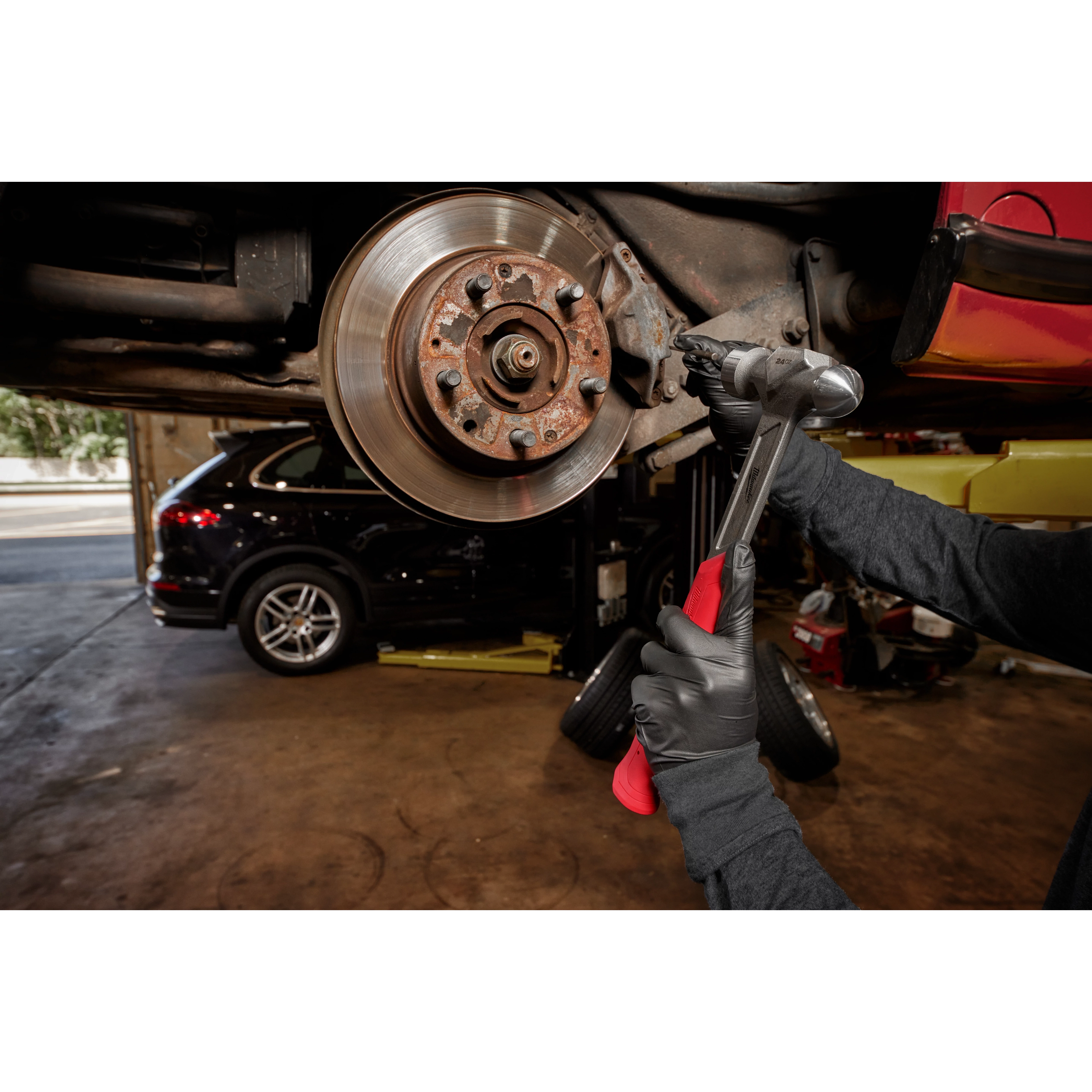 Worker using the 24oz Steel Ball Peen Hammer