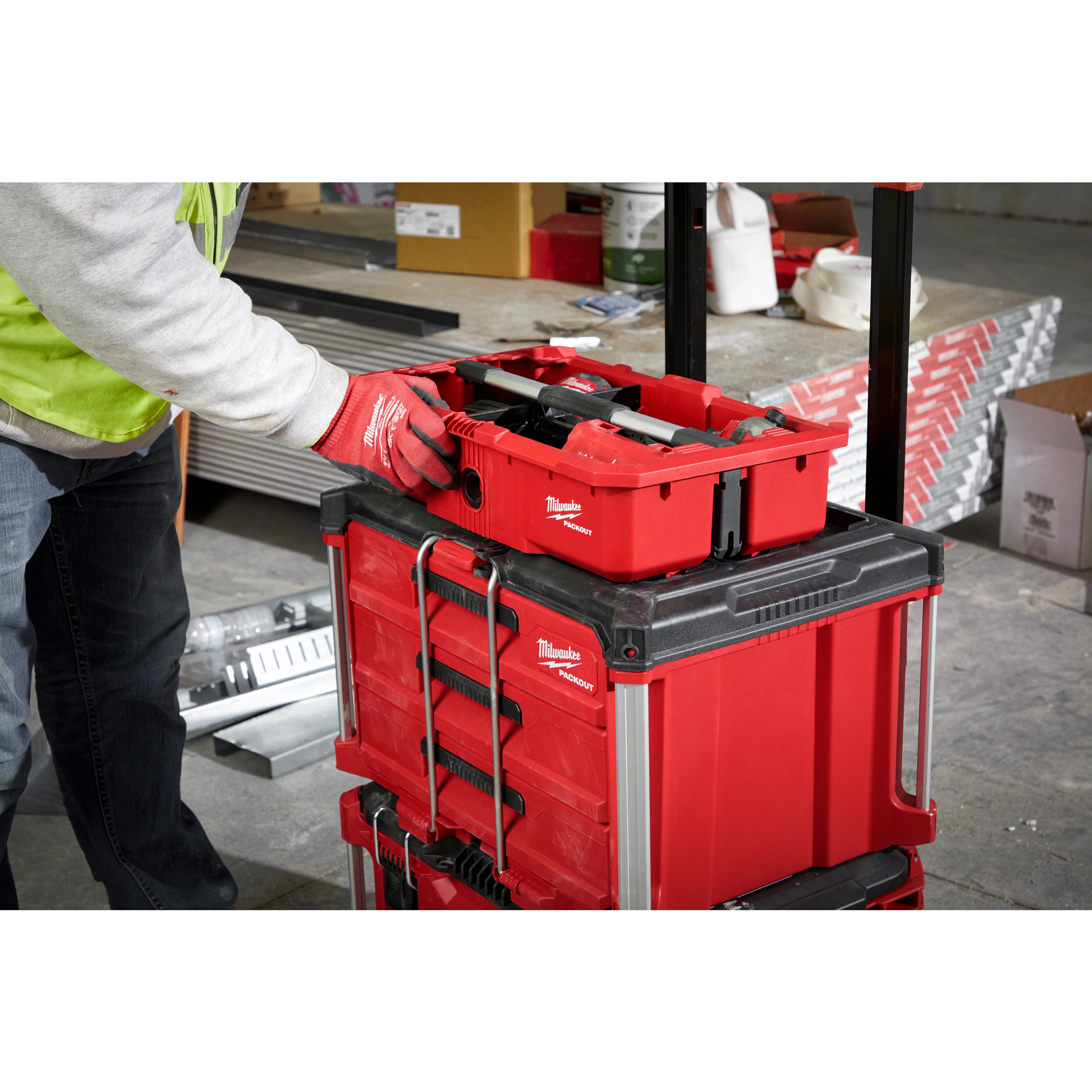 Man putting the PACKOUT Tool Tray inside of the PACKOUT Crate