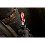 The Milwaukee 9" Cast Iron, Torch w. Nitrus Carbide Sawzall Blade is shown cutting through a thick, rusted iron pipe with ease.