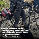 Worker using a cordless concrete vibrator on a construction site, with text overlay: "Way better than dragging around an extension cord and a generator!"