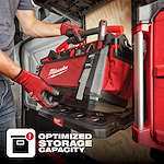 A person places a Milwaukee tool bag onto a shelf. Text reads "Optimized Storage Capacity" with an icon indicating efficient storage.