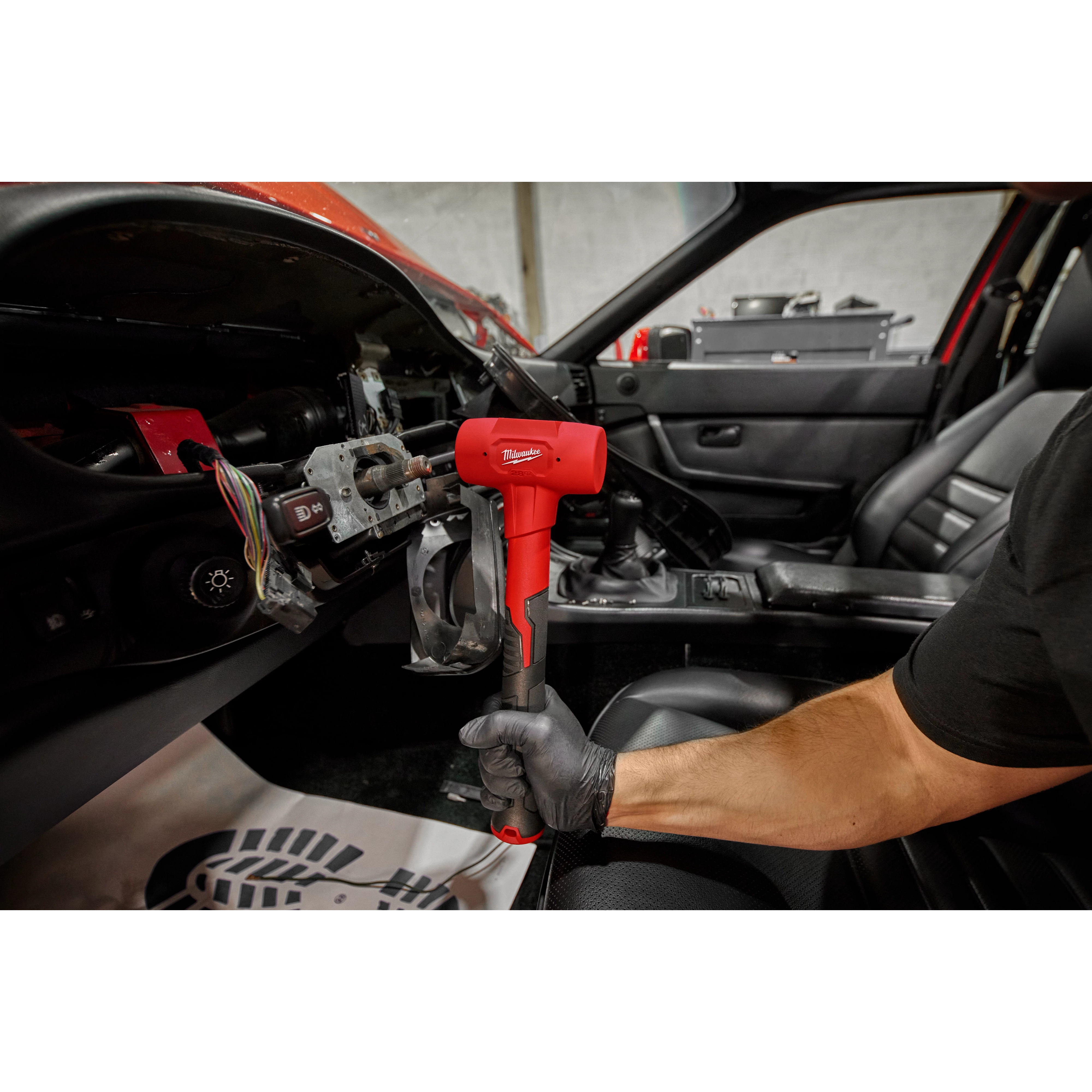 Worker using the 32oz Dead Blow Ball Peen Hammer for automotive use