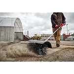 Worker using the M18 FUEL QUIK-LOK Bristle Brush Attachment