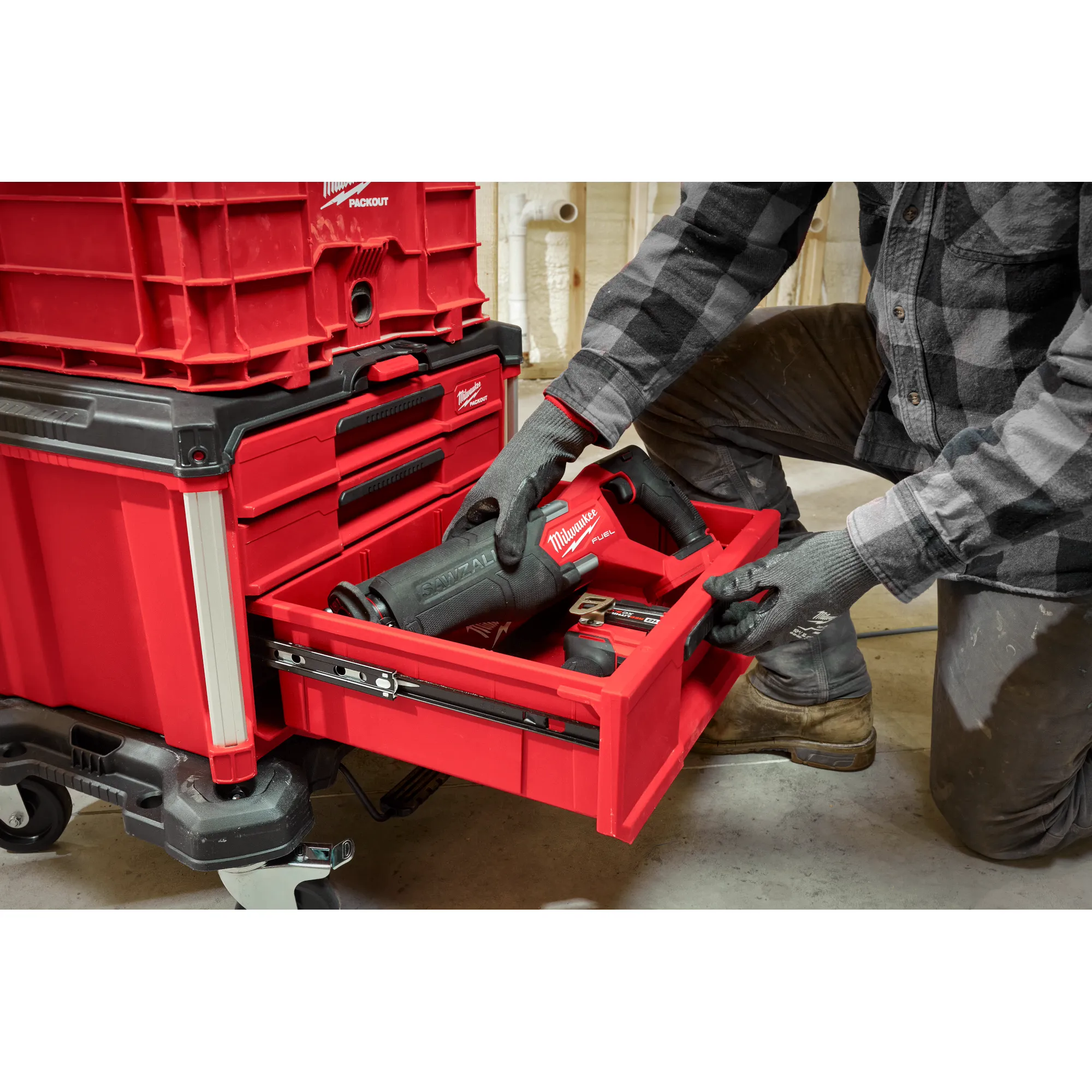 Worker placing a Power Tool in the PACKOUT 3-Drawer Tool Box