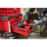 Worker placing a Power Tool in the PACKOUT 3-Drawer Tool Box