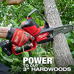 A person uses an M12 FUEL™ HATCHET™ 6" Pruning Saw to cut through a tree branch. The image highlights the tool's power to cut through 3" hardwoods. The saw and the person's glove are branded with Milwaukee logos.