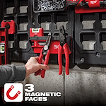The PACKOUT Magnetic Rack is mounted on a black panel, holding red pliers and other tools. It features three magnetic faces.