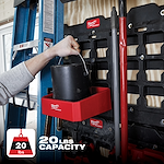 The PACKOUT Compact Shelf is red, mounted on a storage rack, and holds a black container. It has a 20 lbs capacity.